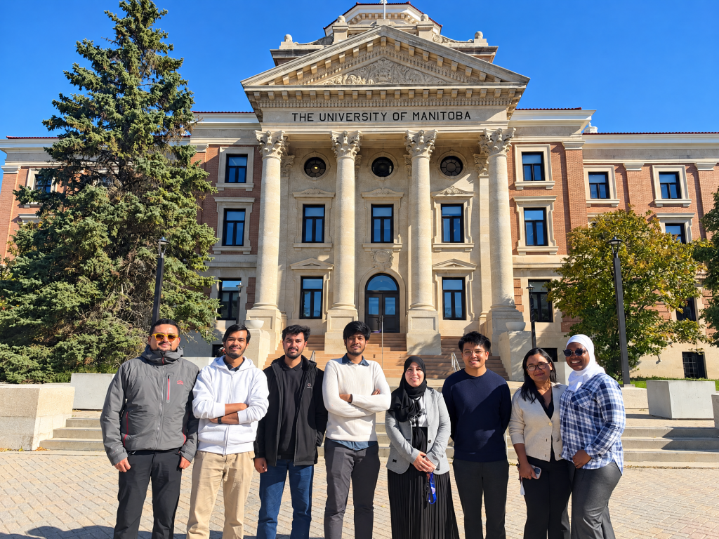 Dr. Houda Elmimouni with her HCI Lab students in front of the Administration Building at the University of Manitoba